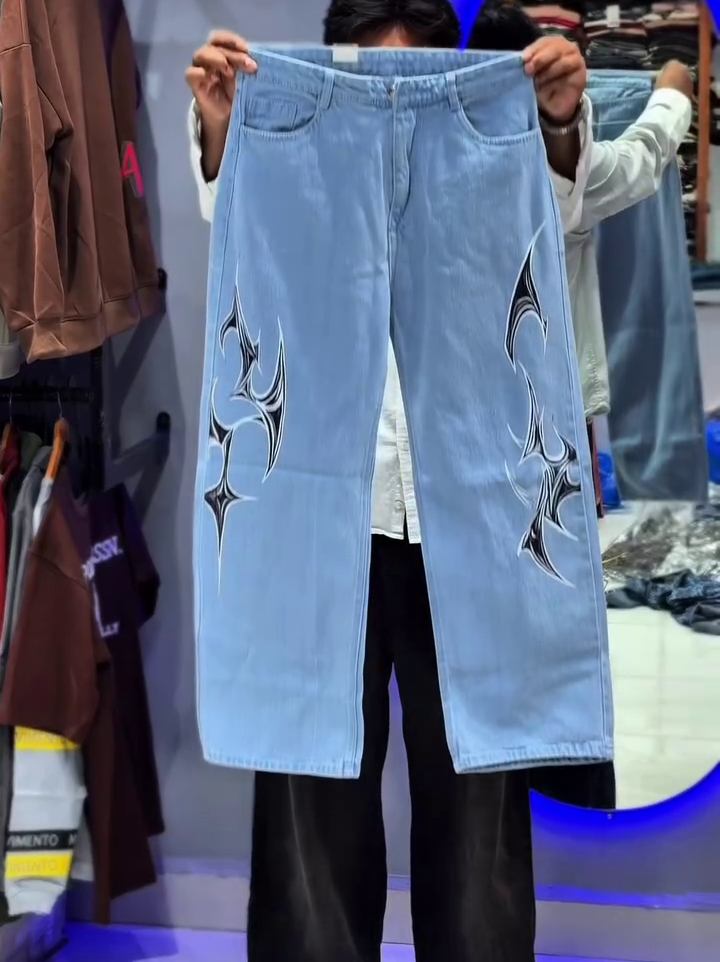 Light Blue Wide-Leg Denim Jeans with Bold Tribal Graphic Design