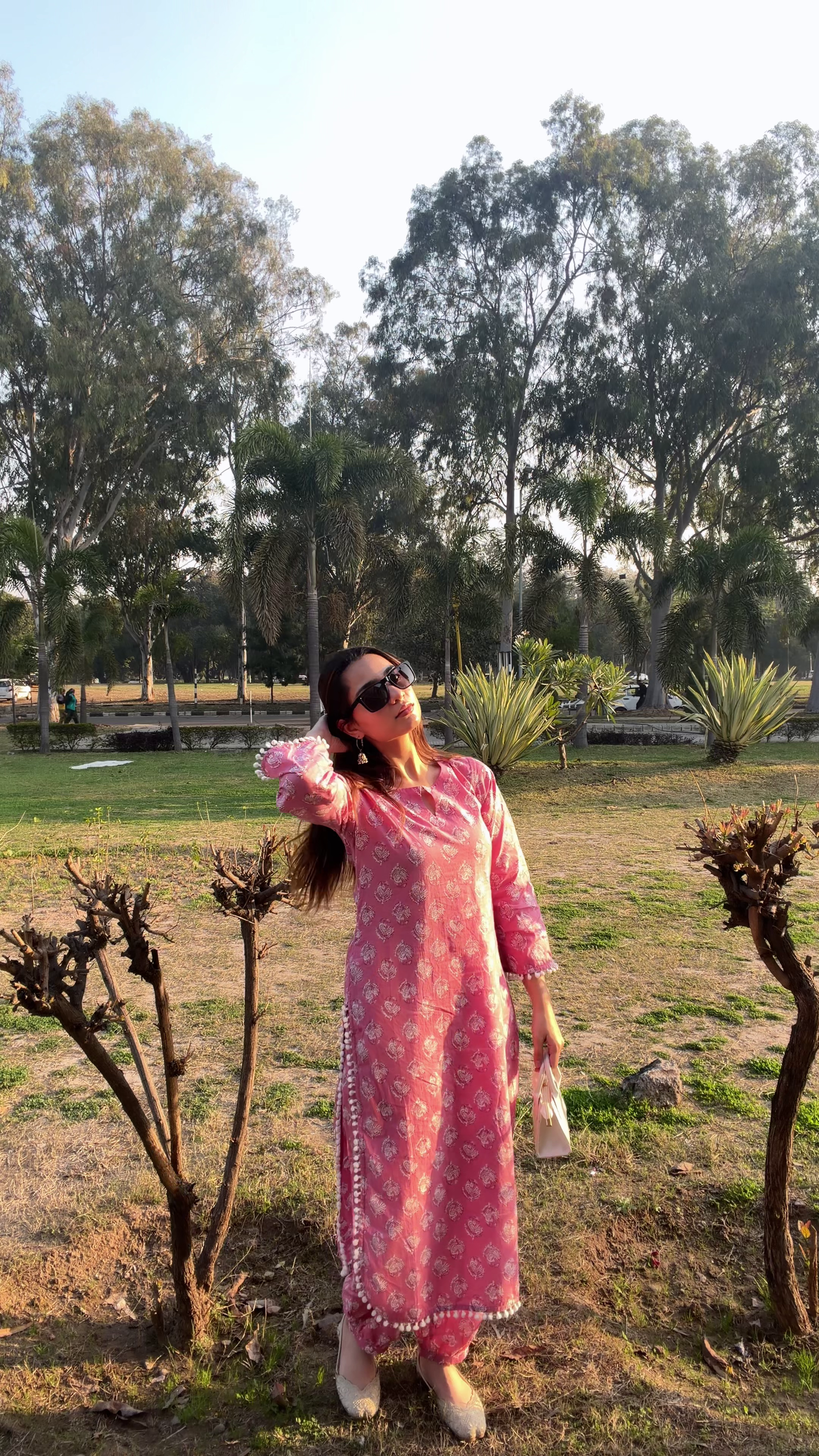 Elegant Pink Traditional Outfit Showcasing Timeless Grace in a Natural Park Setting