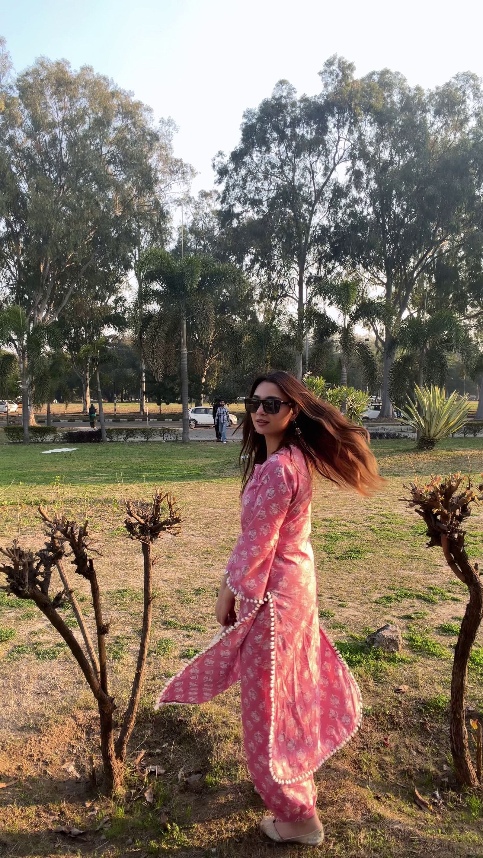 Elegant Pink Traditional Outfit Showcasing Timeless Grace in a Natural Park Setting