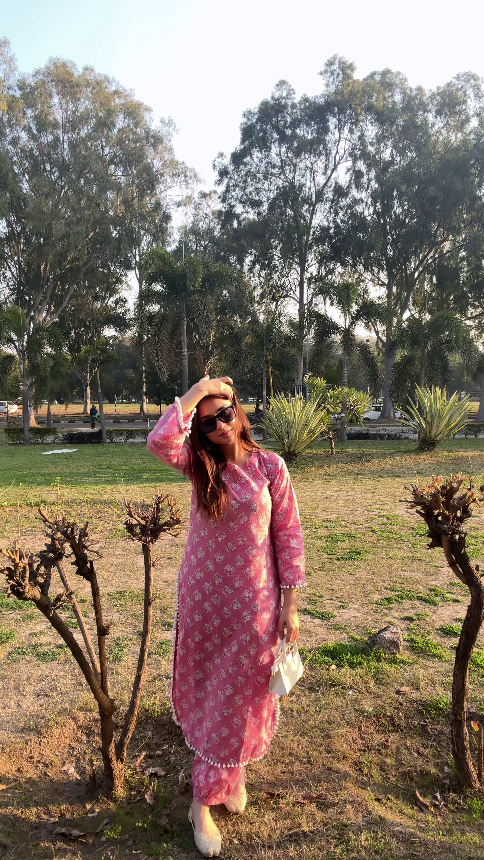 Elegant Pink Traditional Outfit Showcasing Timeless Grace in a Natural Park Setting